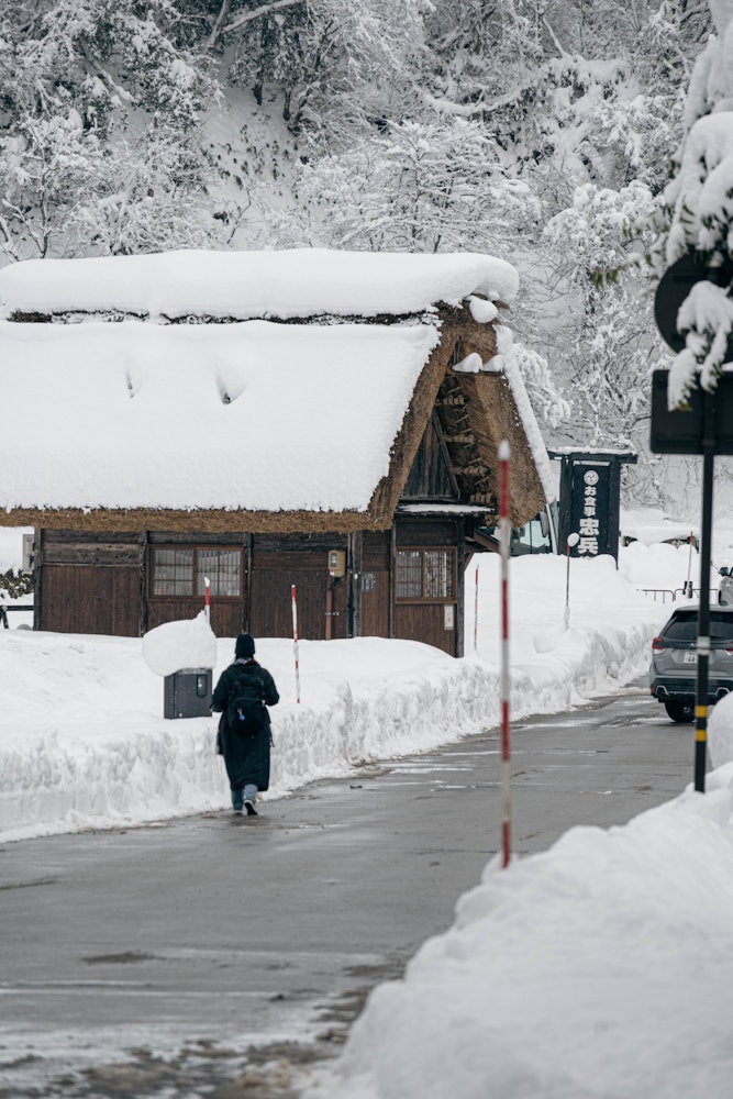 [相片1]这是一位游客走在白川乡白雪皑皑的街道上。