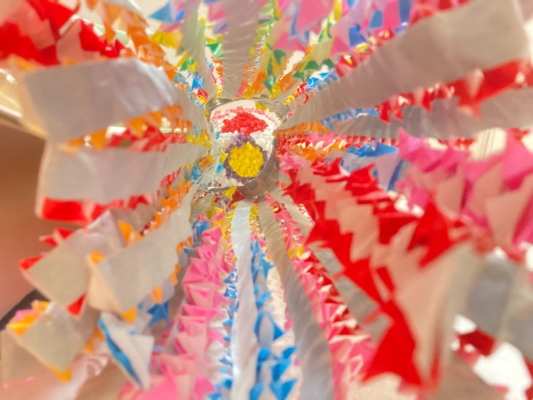 [画像1]子供が年長の時に作った作品。 日本の休日である子供の日に合う折り紙で作った兜を下から撮りました。様々な色の折り紙で折っているのですごくカラフルで色鮮やかに映っておりチャッターを押してみました