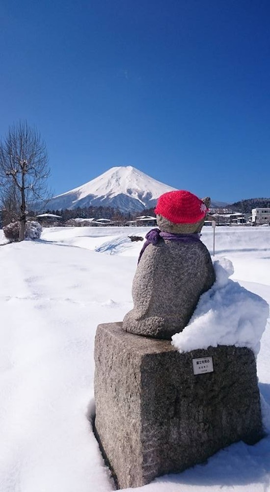 [相片1]當我住在富士吉田市的貝爾貝爾酒店時，這是從酒店附近的農場道路上拍攝的景色。 地藏在雪落後的第二天，在陽光明媚的日子里站在雪地上。 我去過那裡很多次，因為我想拍下這個風景。 地藏戴著紅帽子，仰望著富士山
